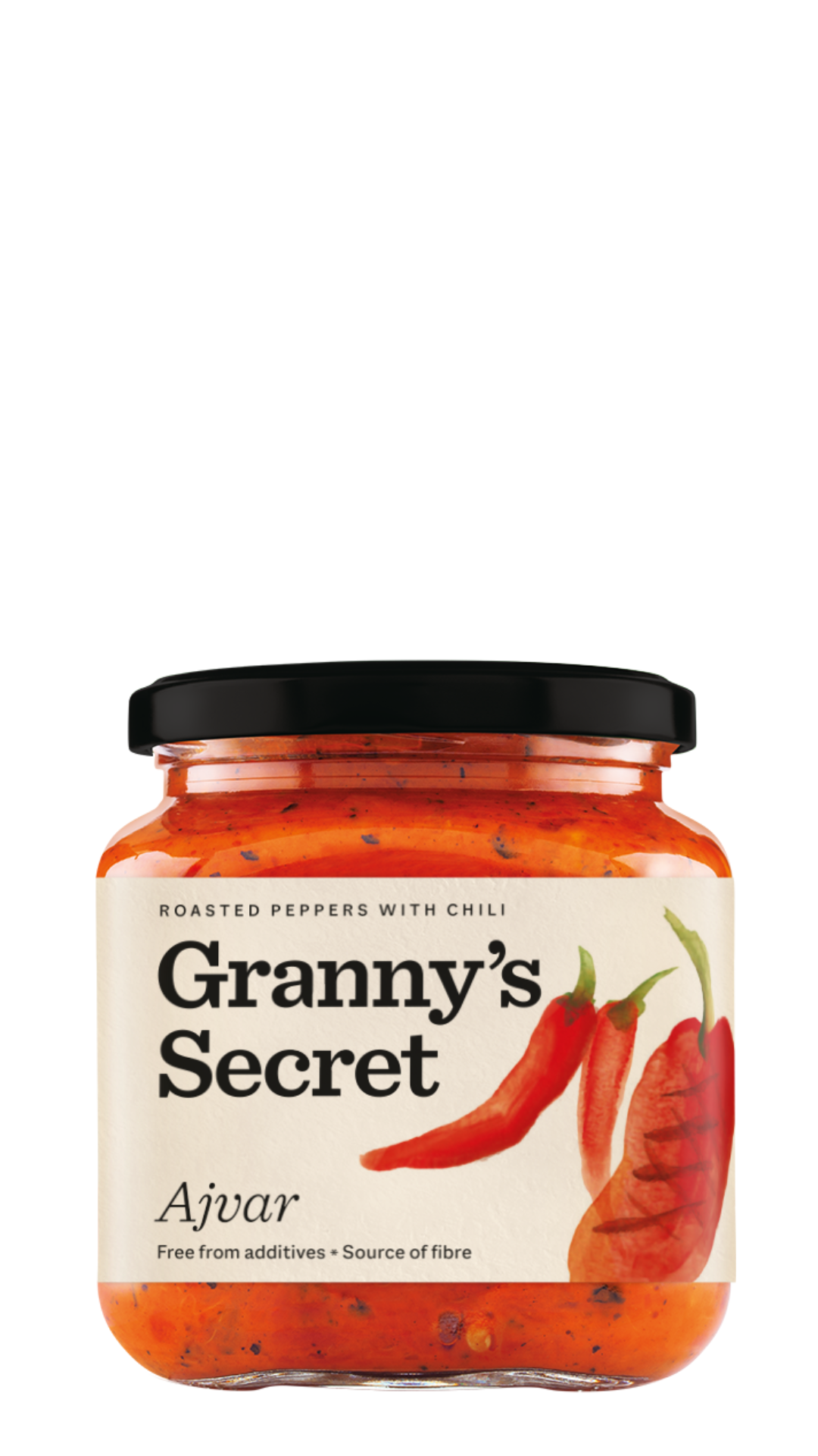 A jar of Granny's Secret Ajvar with visible roasted red peppers and chili peppers, indicating a spicy (hot) flavor variant, in a clear glass jar with a black lid.